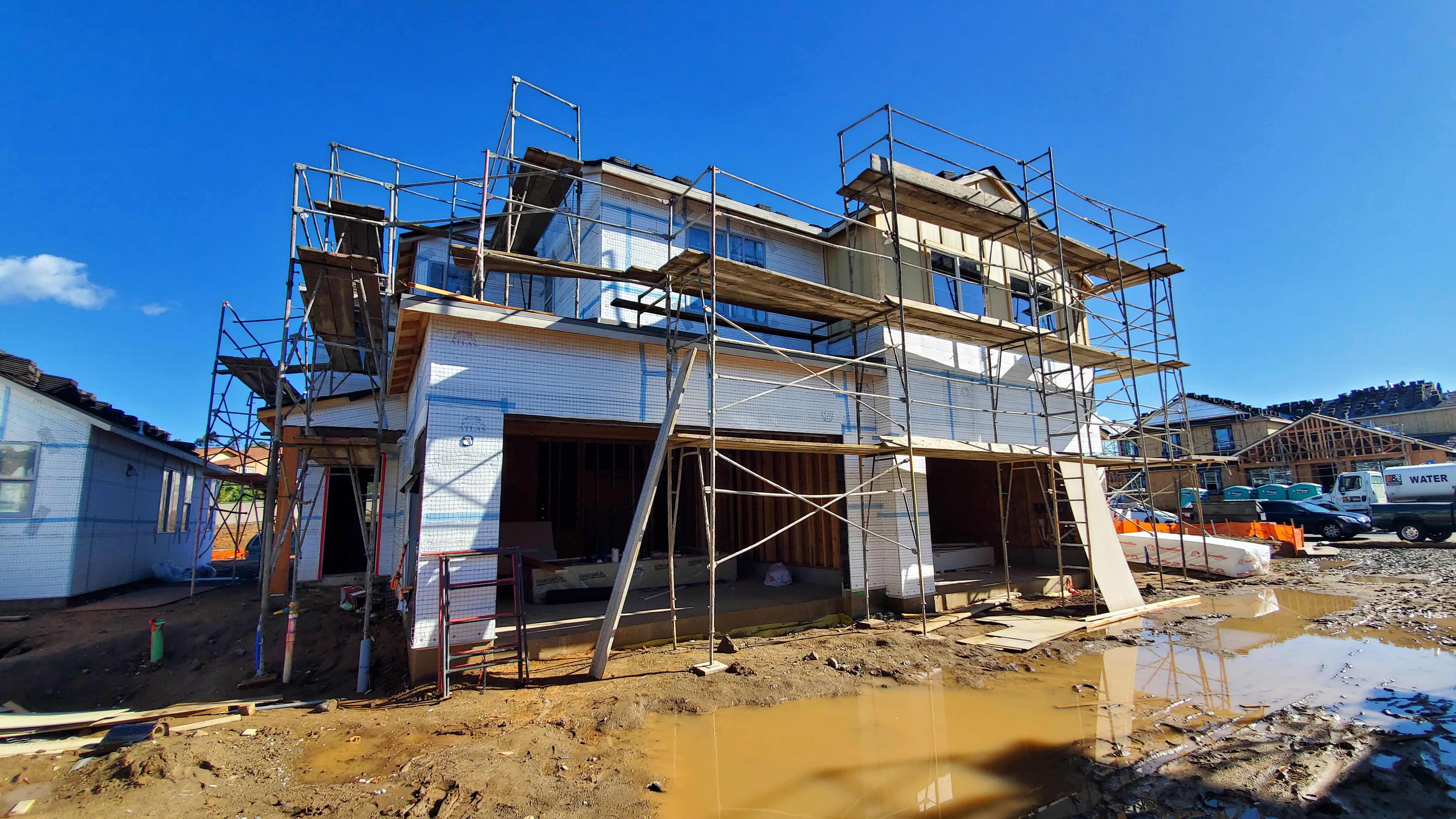 new building under construction covered in scaffolding